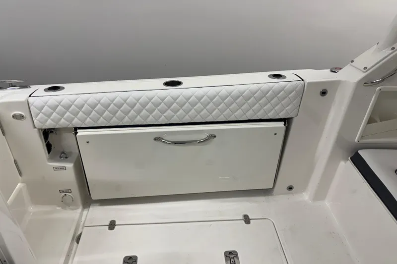 Slide: The Image of 2020 Pursuit DC 365 Dual Console interior with quilted seating and storage compartment. - 22