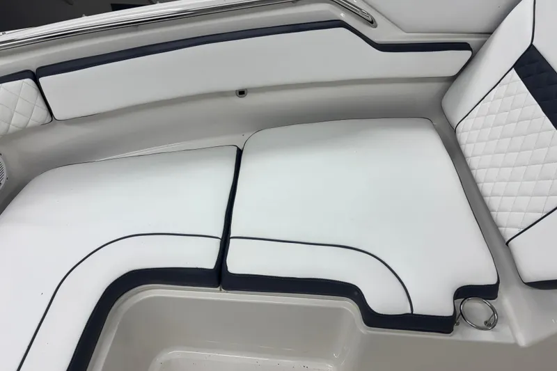 Slide: The Image of 2020 Pursuit DC 365 Dual Console boat interior with white cushioned seating. - 23
