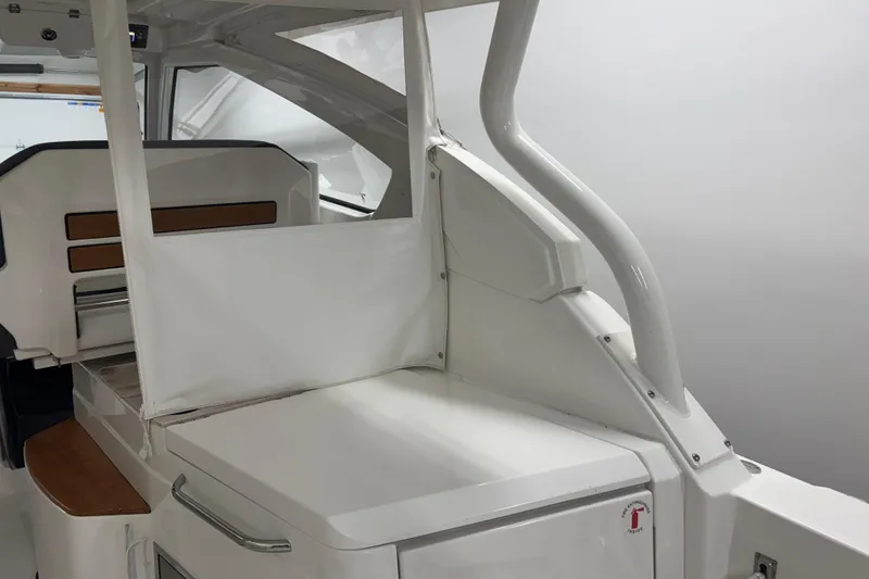 Slide: The Image of 2020 Pursuit DC 365 Dual Console interior with sleek white design and seating area. - 25