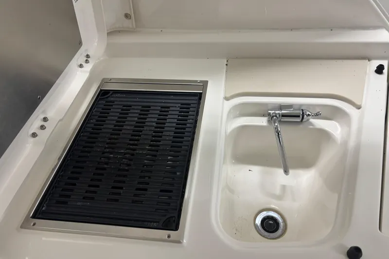 Slide: The Image of 2020 Pursuit DC 365 Dual Console boat sink and grill area. - 27