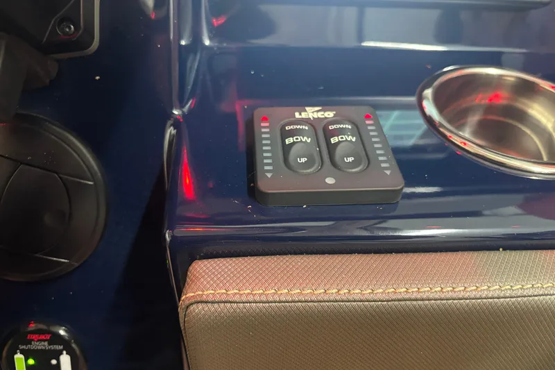Slide: The Image of Control panel of a 2020 Pursuit DC 365 Dual Console boat with Lenco trim tab switches. - 33