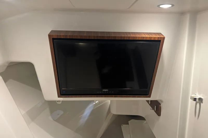 Slide: The Image of 2020 Pursuit DC 365 Dual Console interior with mounted TV and modern lighting. - 40