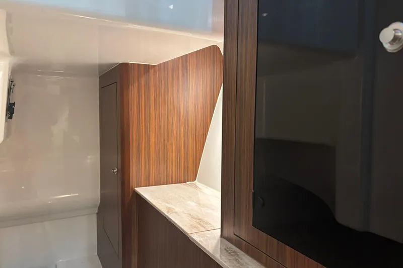 Slide: The Image of 2020 Pursuit DC 365 Dual Console interior with wood finish and storage cabinet. - 43