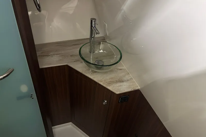 Slide: The Image of 2020 Pursuit DC 365 Dual Console bathroom with glass sink and modern faucet. - 45