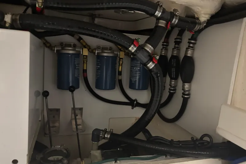 Slide: The Image of Engine compartment of 2020 Pursuit DC 365 Dual Console with fuel filters and hoses. - 52