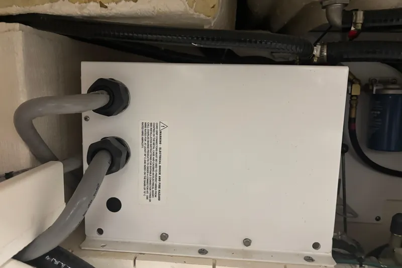 Slide: The Image of Electrical box with cables inside a 2020 Pursuit DC 365 Dual Console boat. - 54