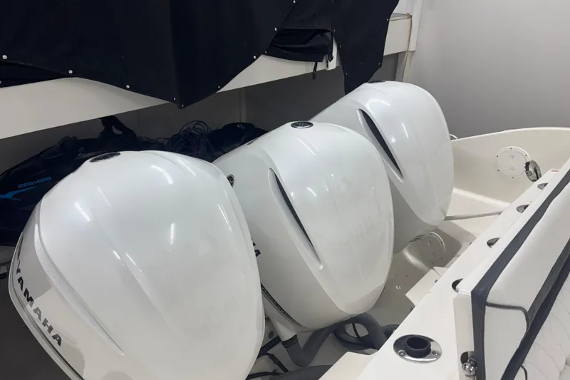 Slide: The Image of 2020 Pursuit DC 365 Dual Console with triple Yamaha outboard engines in storage. - 66