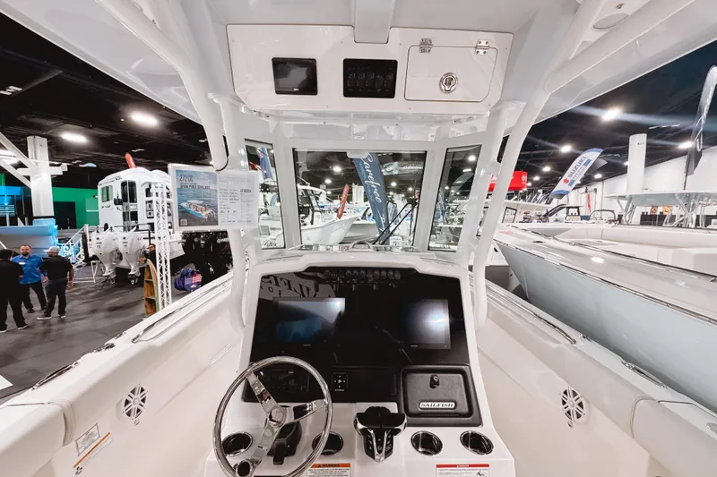Slide: The Image of Interior view of 2026 Sailfish 272 CC boat at a showroom display. - 5