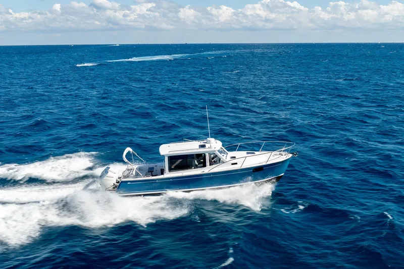 Slide: The Image of 2025 MJM 35 boat cruising on open ocean under clear skies. - 10