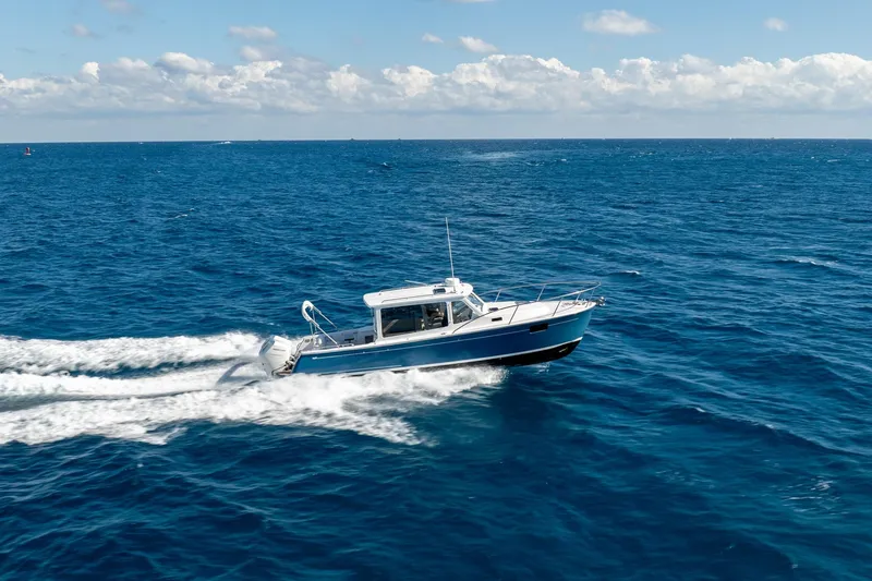 Slide: The Image of 2025 MJM 35 boat cruising on open ocean under clear skies. - 11