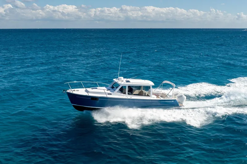 The Image of 2025 MJM 35 boat cruising on open blue ocean under clear skies. - 2
