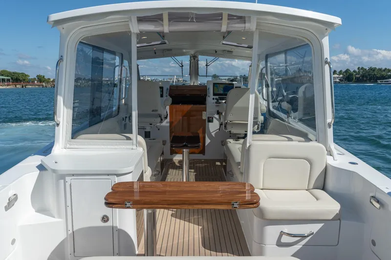 Slide: The Image of 2025 MJM 35 boat interior with seating and navigation equipment on a sunny day. - 24