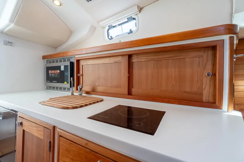 Slide: The Image of Modern kitchen in 2025 MJM 35 yacht with wood cabinetry and sleek appliances. - 32