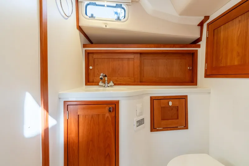 Slide: The Image of Luxurious 2025 MJM 35 yacht bathroom with wooden cabinetry and modern fixtures. - 35