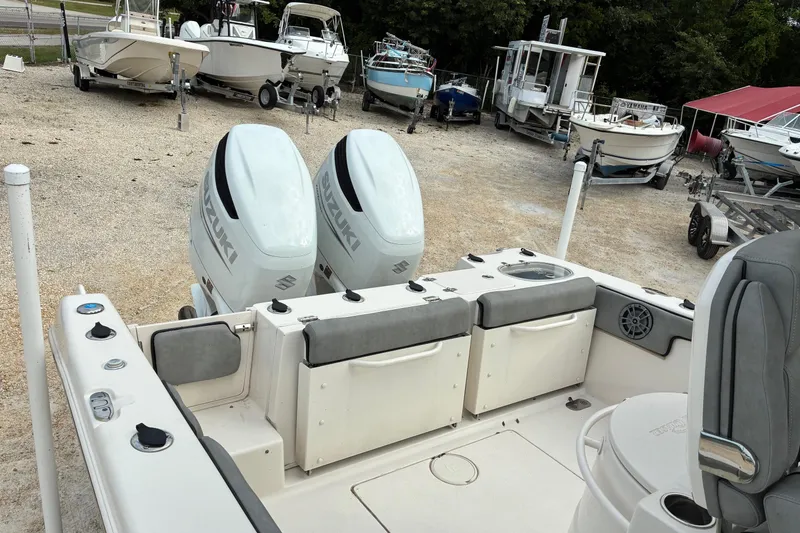 Slide: The Image of 2023 Sea Chaser 27 HFC CC boat with dual Suzuki engines in a boatyard. - 3