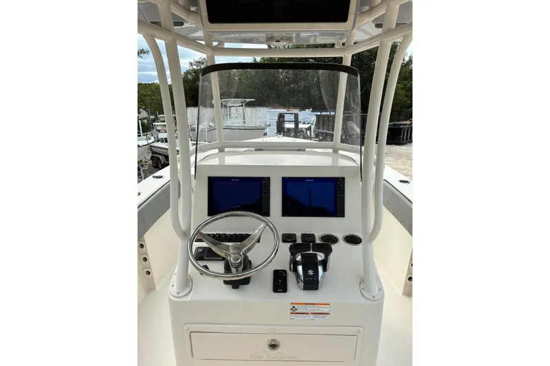 Slide: The Image of 2023 Sea Chaser 27 HFC CC boat console with dual screens and steering wheel. - 5