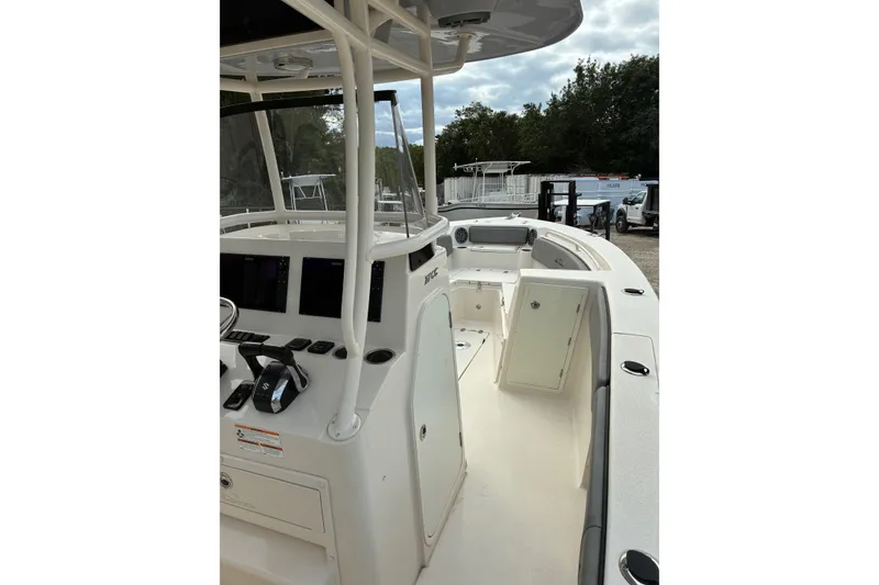 Slide: The Image of 2023 Sea Chaser 27 HFC CC boat interior with helm and seating area. - 6