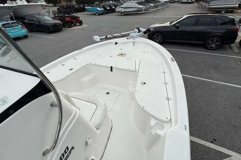 Slide: The Image of 2015 Sea Fox 200 Viper boat in parking lot, showcasing spacious deck and storage compartments. - 11