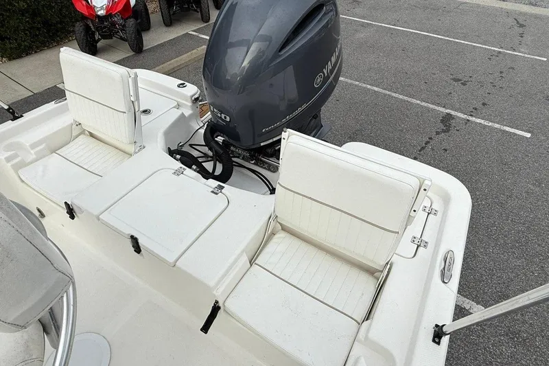 Slide: The Image of 2015 Sea Fox 200 Viper boat with Yamaha engine, featuring white seating and storage compartments. - 14