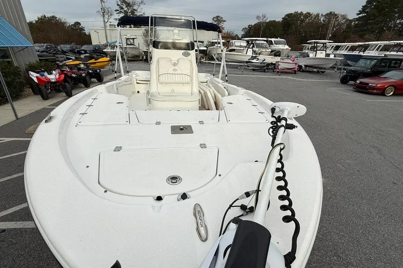 Slide: The Image of 2015 Sea Fox 200 Viper boat in a dealership lot, surrounded by various vehicles. - 6