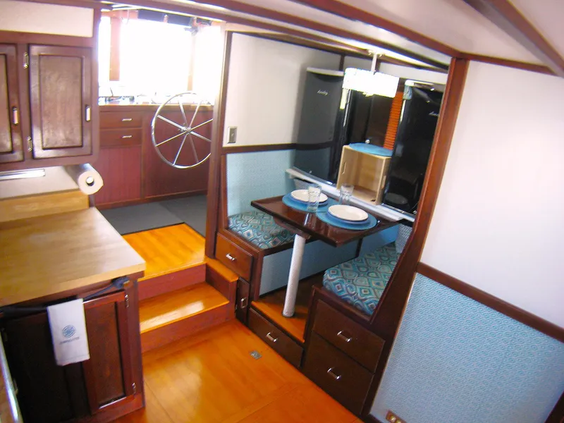 Slide: The Image of Interior of 1987 Custom Pilgrim Tribute boat with dining area and kitchen. - 11