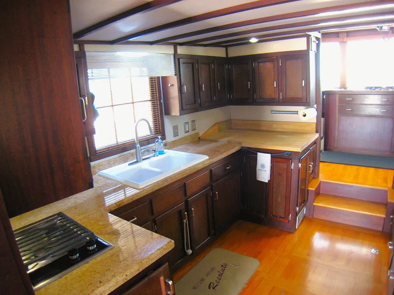 Slide: The Image of Spacious kitchen in 1987 Custom Pilgrim Tribute boat with wooden cabinets and countertops. - 13
