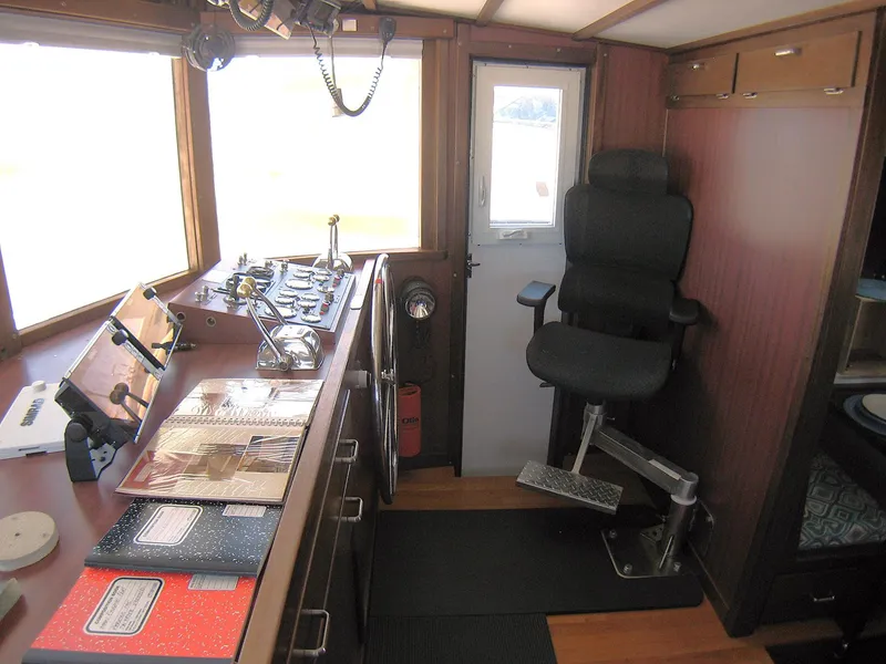 Slide: The Image of 1987 Custom Pilgrim Tribute boat interior with control panel and captain's chair. - 16