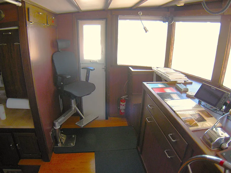 Slide: The Image of 1987 Custom Pilgrim Tribute boat interior with control panel and captain's chair. - 17