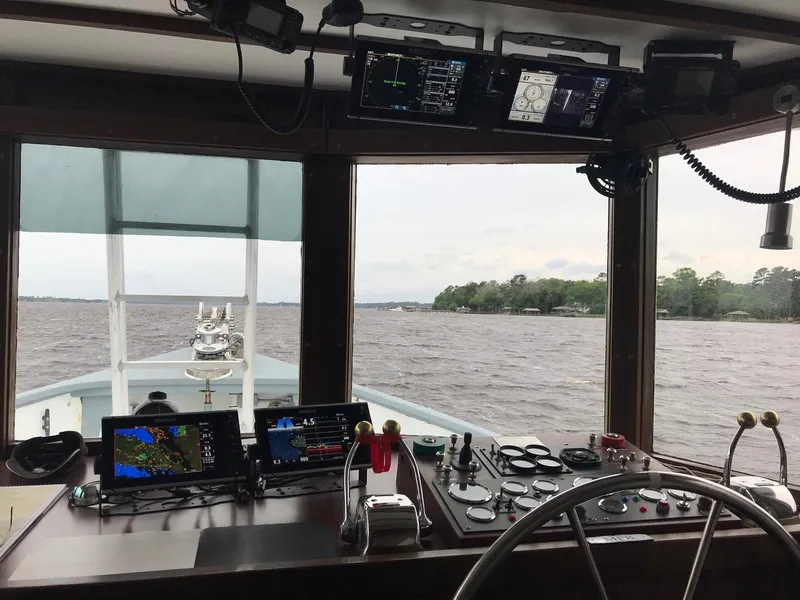 Slide: The Image of Pilgrim Tribute 1987 boat cockpit with navigation equipment, steering wheel, and water view. - 18
