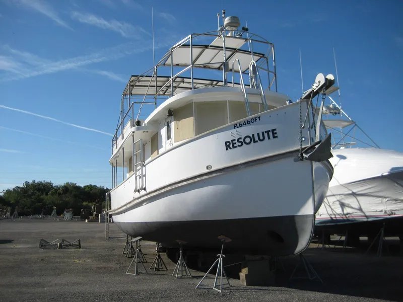 Slide: The Image of 1987 Custom Pilgrim Tribute boat "Resolute" on dry dock under clear blue sky. - 2