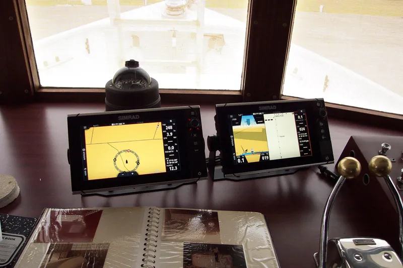 Slide: The Image of Pilgrim Tribute 1987 boat dashboard with navigation screens and controls. - 20