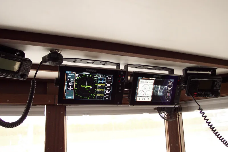 Slide: The Image of 1987 Custom Pilgrim Tribute boat navigation equipment with radar and communication displays. - 21