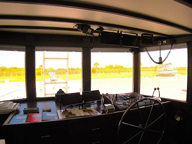 Slide: The Image of Pilgrim Tribute 1987 boat interior with steering wheel and navigation equipment. - 22