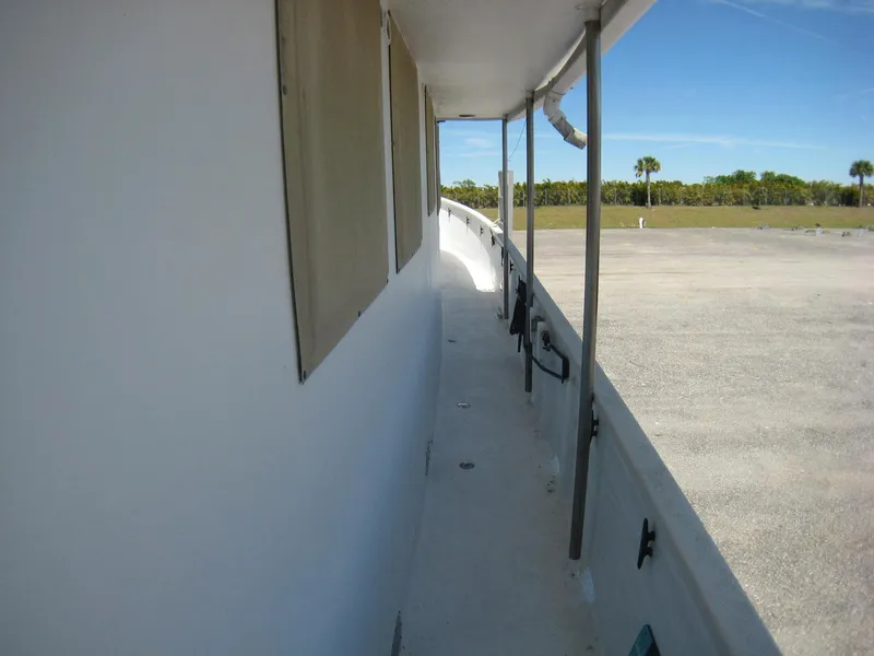 Slide: The Image of Side view of 1987 Custom Pilgrim Tribute boat docked on a sunny day. - 27