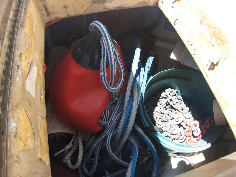 Slide: The Image of Storage compartment with ropes, red buoy, and chain on a 1987 Custom Pilgrim Tribute boat. - 31