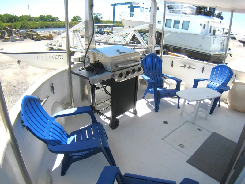 Slide: The Image of Outdoor deck of 1987 Custom Pilgrim Tribute with blue chairs and grill. - 39