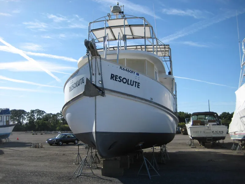Slide: The Image of Custom 1987 Pilgrim Tribute boat "Resolute" on dry dock, clear sky background. - 4