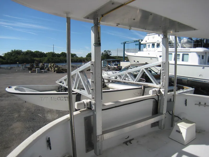 Slide: The Image of 1987 Custom Pilgrim Tribute boat docked, featuring a white deck and metal framework. - 40