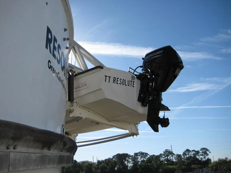 Slide: The Image of Boat with Mercury outboard motor, labeled "TT Resolute," under clear blue sky. - 41