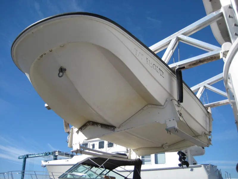 Slide: The Image of 1987 Custom Pilgrim Tribute boat on lift against blue sky background. - 43