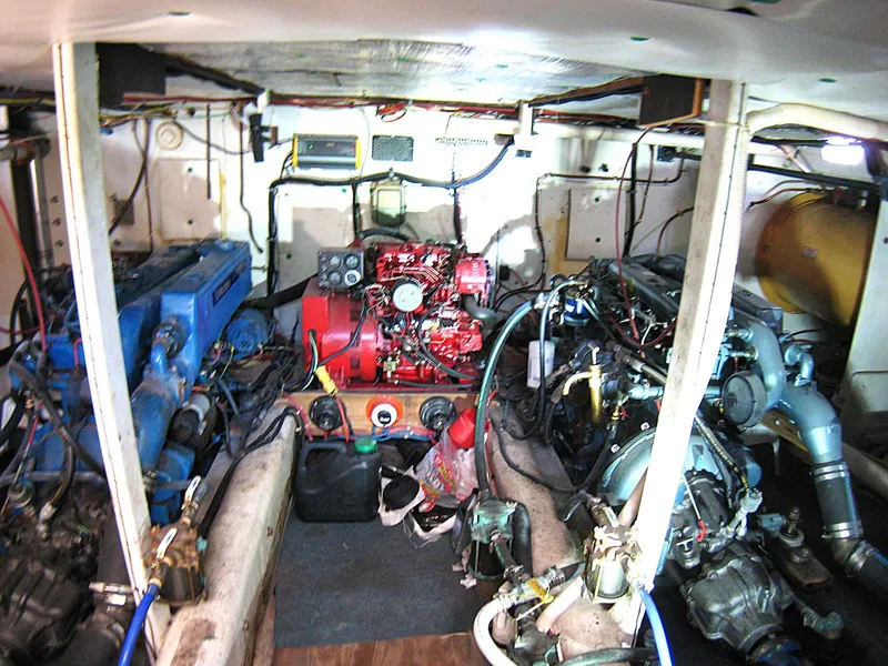 Slide: The Image of Engine room of 1987 Custom Pilgrim Tribute boat with visible machinery and wiring. - 44
