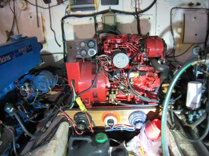Slide: The Image of Engine room of a 1987 Custom Pilgrim Tribute boat with visible wiring and components. - 45