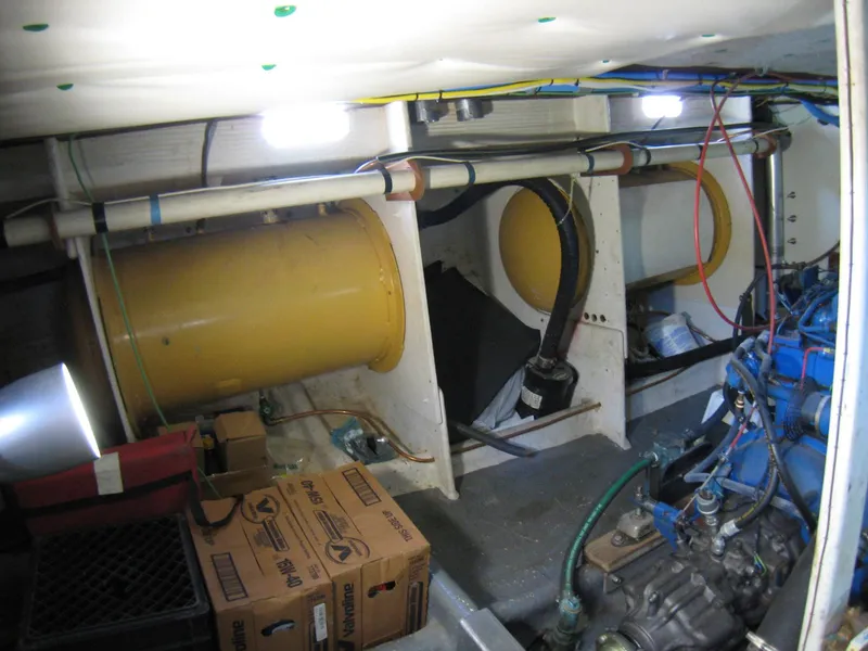 Slide: The Image of Engine room of 1987 Custom Pilgrim Tribute boat with visible machinery and storage boxes. - 46