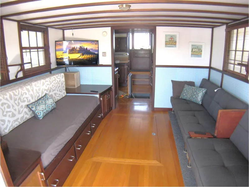 Slide: The Image of Interior of 1987 Custom Pilgrim Tribute boat with modern furnishings and wooden flooring. - 8
