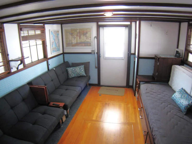Slide: The Image of Interior of 1987 Custom Pilgrim Tribute boat with cozy seating and wooden flooring. - 9