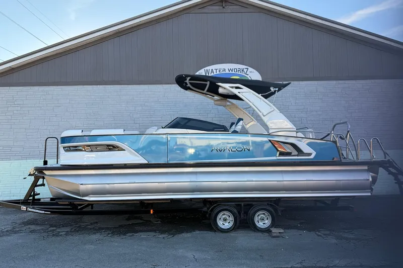 The Image of 2026 Avalon 2585 Excalibur LTD Flex Windshield pontoon boat on trailer, side view. - 0