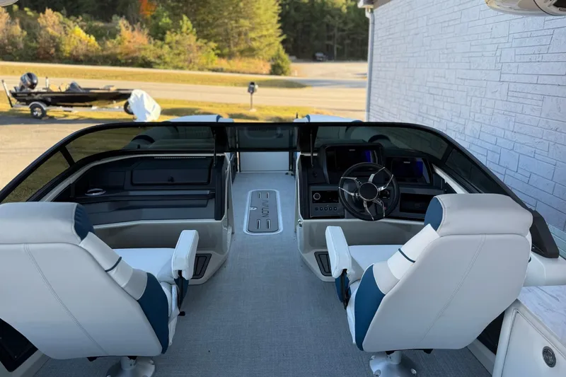 Slide: The Image of 2026 Avalon 2585 Excalibur LTD boat interior with modern dashboard and seating. - 14