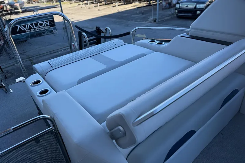 Slide: The Image of 2026 Avalon 2585 Excalibur LTD Flex Windshield boat interior with luxurious seating and cup holders. - 17