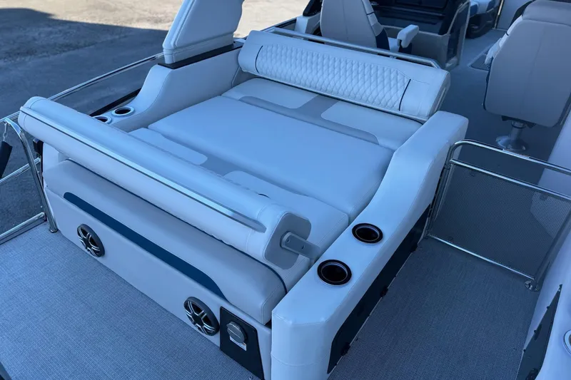 Slide: The Image of Luxurious seating on 2026 Avalon 2585 Excalibur LTD Flex Windshield boat, featuring cup holders and speakers. - 18