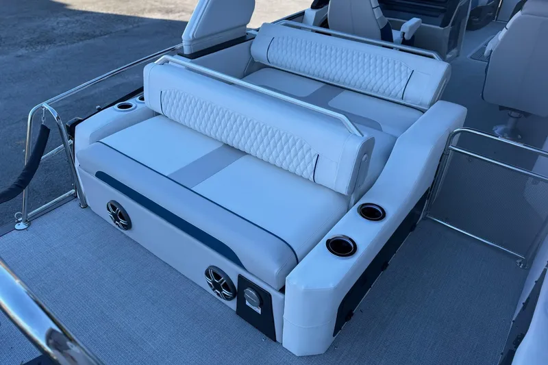 Slide: The Image of Luxurious seating on 2026 Avalon 2585 Excalibur LTD Flex Windshield boat, featuring cup holders and speakers. - 19